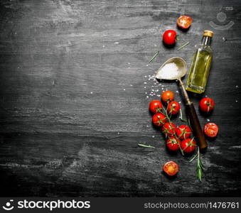 Fresh tomatoes with olive oil and a spoon of salt. On black rustic background.. Fresh tomatoes with olive oil and a spoon of salt.