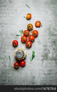 Fresh tomatoes with salt and rosemary. On a stone background. . Fresh tomatoes with salt and rosemary.