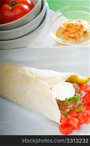 fresh traditional falafel wrap on pita bread with fresh chopped tomatoes