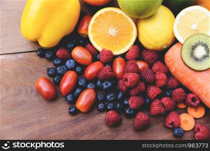 Fresh tropical fruits colorful and vegetables summer healthy foods / Many ripe fruit mixed on wooden background