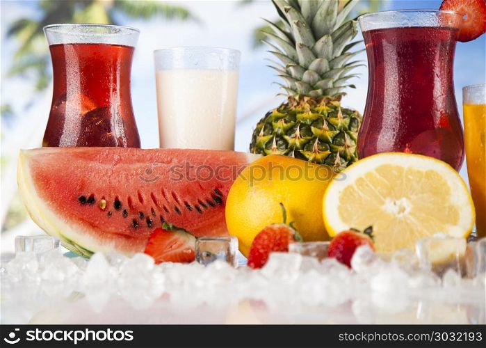 Fresh tropical fruits, Summer drink and palm branch. Variety of cold drinks, Summer