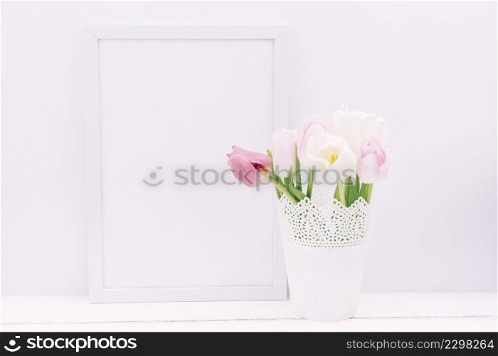 fresh tulip flowers vase with blank frame