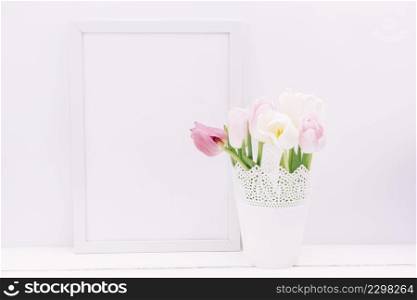 fresh tulip flowers vase with blank frame