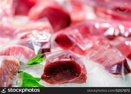 Fresh tuna fish on cooled market display