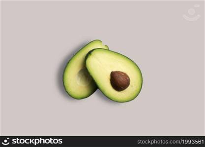 Fresh two slices avocado on a white background for the menu. Geometric background. Flat lay, copy space, top view.