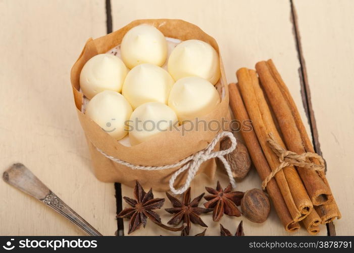 fresh vanilla and spice cream cake dessert over a rustic white wood table