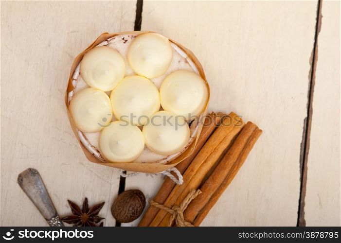 fresh vanilla and spice cream cake dessert over a rustic white wood table