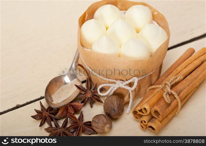 fresh vanilla and spice cream cake dessert over a rustic white wood table
