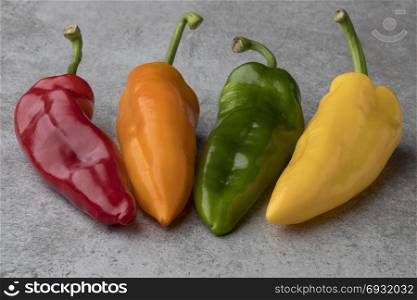 Fresh variety of red, yellow, orange and green sweet pointed peppers