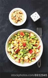 Fresh vegan chickpea, celery, grape and apple salad with parsley, roasted almond slices on the side, photographed overhead on slate with natural light (Selective Focus, Focus on the salad). Chickpea, Celery, Grape and Apple Salad