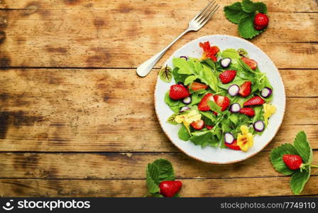 Fresh vegan salad of green ripe strawberries.Summer vitamin salad.. Summer salad with berries and herbs