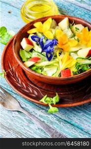 Fresh vegan salad with edible flowers. Vegetarian salad leaves with herbs and flowers.Healthy spring salad