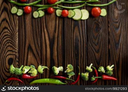 Fresh vegetable decoration on wooden background, top view. Organic vegetarian food, grocery assortment, natural eco products, healthy lifestyle concept. Fresh vegetable decoration on wooden background