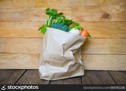 Fresh vegetable from market take away paper bag shopping on wooden table, Delivery healthy food in paper bag grocery shopping concept