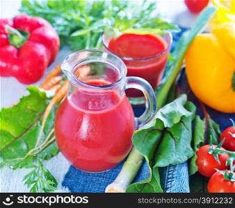 fresh vegetable juice in the glass and on a table