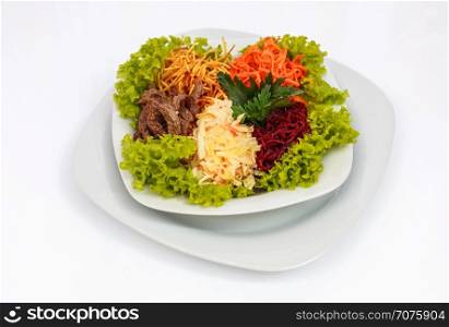 fresh vegetable salad. Fresh vegetable salad with slices of meat, filmed on a sheet of white plastic, close-up
