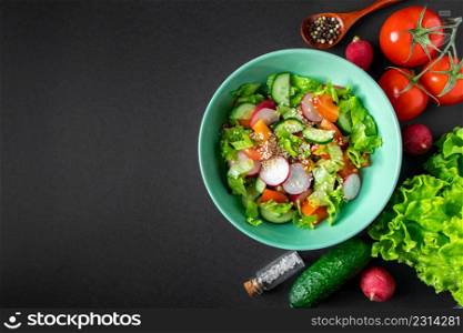 Fresh vegetable salad in a ceramic bowl on a gray background. Seasonal summer dish of tomatoes, cucumbers and radishes. Place for text.. Fresh vegetable salad in a ceramic bowl on gray background. Seasonal summer dish of tomatoes, cucumbers and radishes.