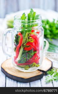 fresh vegetable salad in glass and on a table