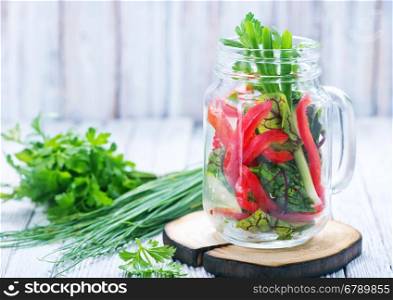 fresh vegetable salad in glass and on a table