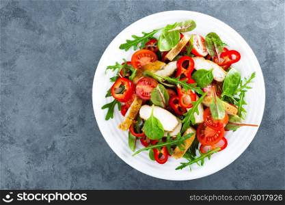 Fresh vegetable salad plate of tomatoes, spinach, pepper, arugula, chard leaves and grilled chicken breast. Fried chicken meat, fillet with salad. Healthy food. Diet dinner or lunch menu. Salad plate on table. Flat lay. View from above