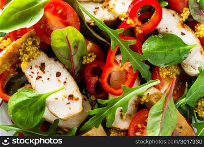 Fresh vegetable salad plate of tomatoes, spinach, pepper, arugula, chard leaves and grilled chicken breast. Fried chicken meat, fillet with salad. Healthy food. Diet dinner or lunch menu. Salad plate on table. Flat lay. View from above