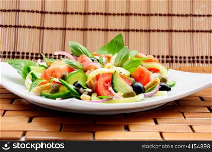Fresh vegetable salad with basil, capers, olives, marinated with croutons