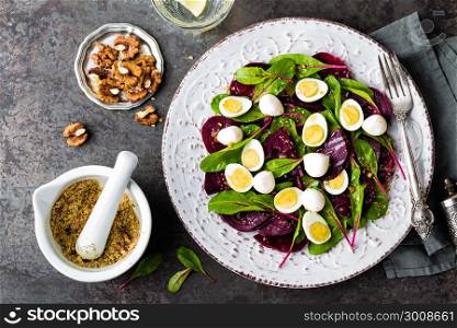 Fresh vegetable salad with boiled beet, mangold leaves, walnuts and quail eggs