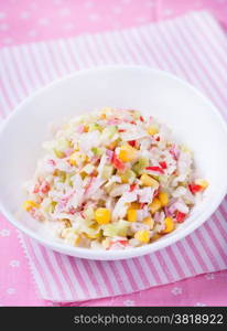 Fresh vegetable salad with corn, cabbage, crab and mayonnaise, selective focus