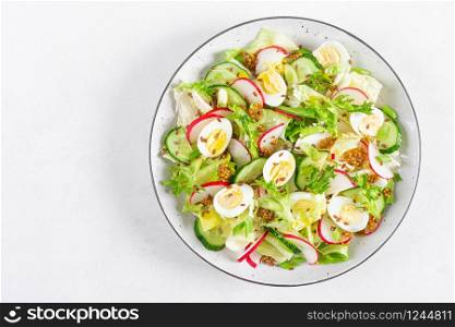 Fresh vegetable salad with cucumber, radish, lettuce and boiled eggs. Helathy food. Top view. Flat lay