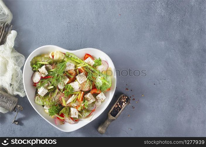 fresh vegetable salad with feta cheese and spice