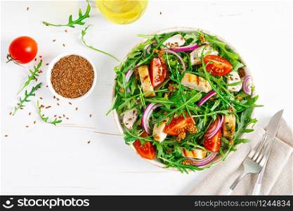 Fresh vegetable salad with grilled chicken fillet, breast, tomato and arugula, top view