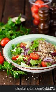 Fresh vegetable salad with lettuce, onion, tomatoes and buckwheat porridge. Healthy vegan food