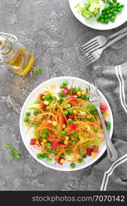 Fresh vegetable salad with raw carrot, green peas, corn, sweet pepper and lettuce. Healthy vegan, vegetarian lunch menu. Top view