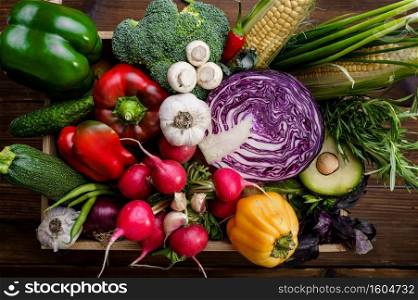 Fresh vegetable set on wooden board closeup, top view. Organic vegetarian food, grocery assortment, natural eco products, healthy lifestyle. Vegetable set on wooden board closeup, top view