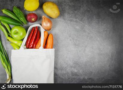 Fresh vegetables and fruit organic in eco cotton fabric bags on table tote canvas cloth bag from market free plastic shopping / Zero waste use less plastic concept