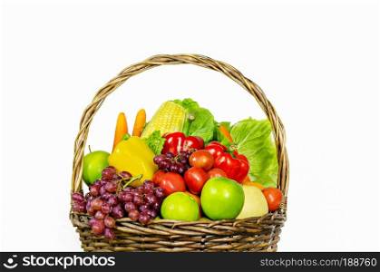 fresh vegetables and fruits in wicker basket over white background. vegetables and fruits in wicker basket 