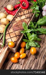 Fresh vegetables and greens on old wooden background. Harvest fresh vegetables and greens