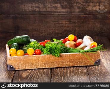 fresh vegetables and herbs in wooden box