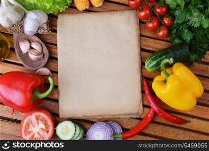 fresh vegetables and olive oil on wooden background