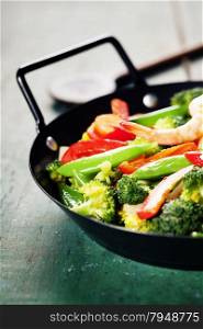 Fresh vegetables and shrimps on pan. Food background