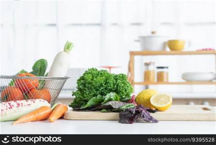 Fresh vegetables and yellow lemon placed on cutting board, tomatoes, white radish, cos salad in basket, carrots, corn on table. Healthy and vegetarian food in home kitchen