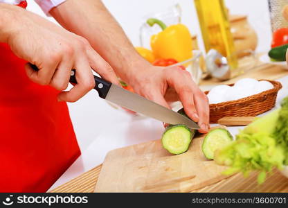 Fresh vegetables being cut with a knife