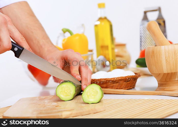 Fresh vegetables being cut with a knife