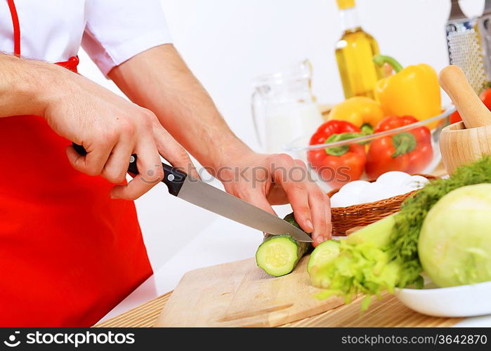 Fresh vegetables being cut with a knife