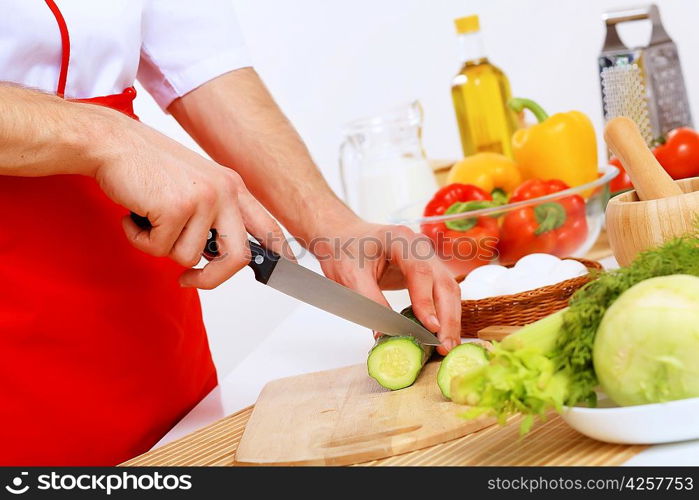 Fresh vegetables being cut with a knife