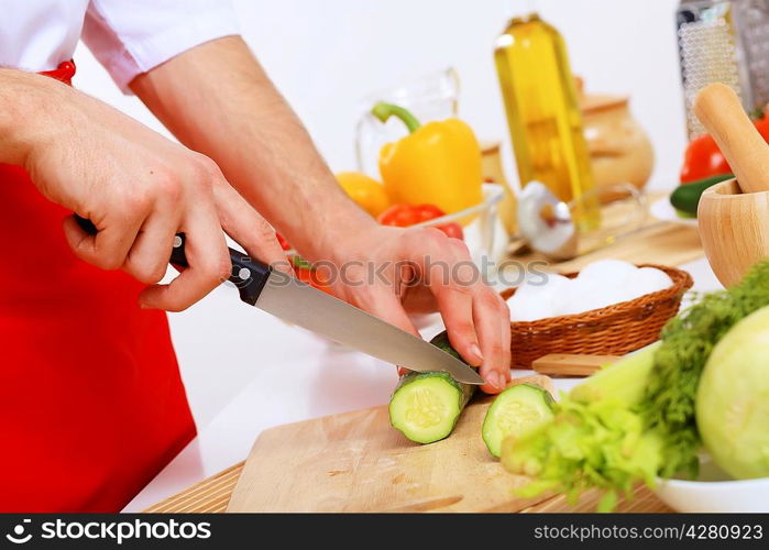 Fresh vegetables being cut with a knife