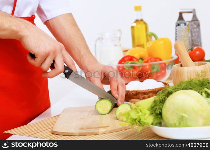 Fresh vegetables being cut with a knife