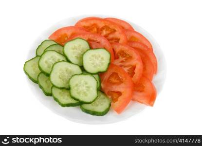 Fresh vegetables: cucumbers and tomatoes on plate
