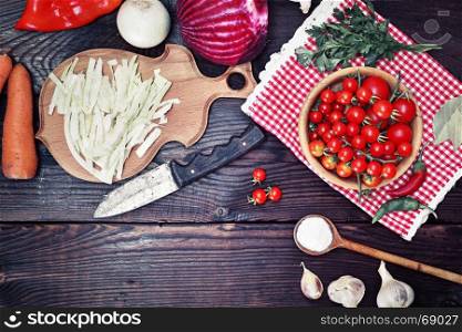 Fresh vegetables for cooking traditional Ukrainian soup borscht on a brown wooden background, top view