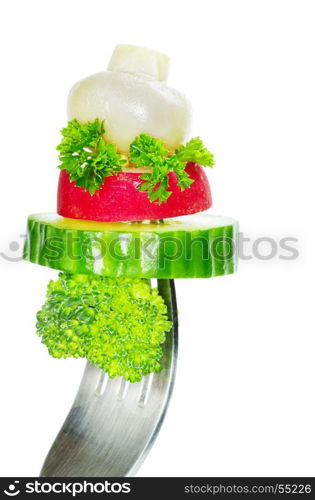 Fresh vegetables on a fork isolated on white background